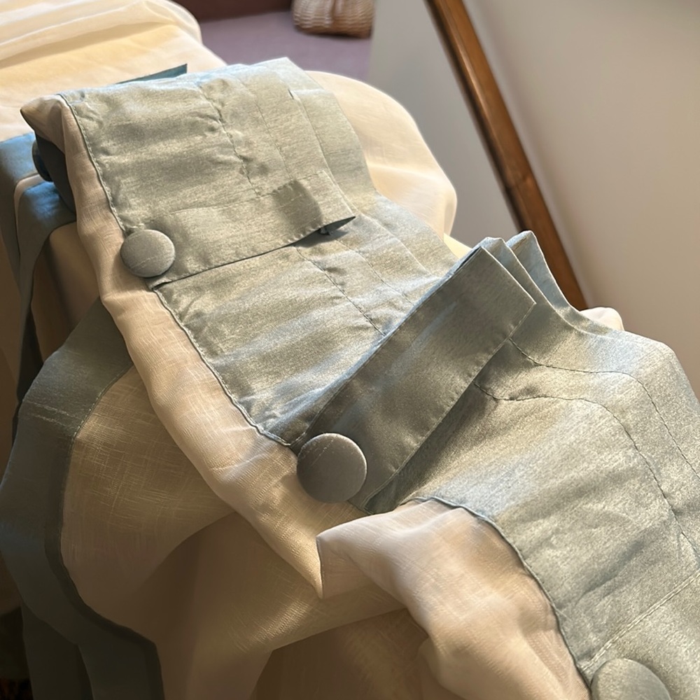 Semi sheer curtains with blue trim. Two very wide panels
